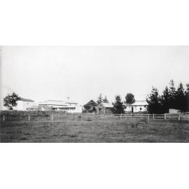 Dairy buildings from left (East) silos, cow bails and feeding stalls, calf pens, dairy factory (print 1 of 2) - Uncropped version [Hawkesbury Agricultural College (HAC)]