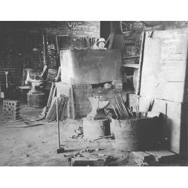 Blacksmith Shop (interior) - Two men at work [Hawkesbury Agricultural College (HAC)]