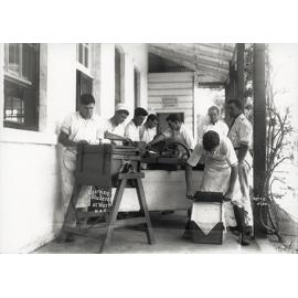 Dairy Factory (exterior): A posed photo of dairy students making butter under supervision on verandah of dairy factory (Print 1 of 2) - Uncropped [Hawkesbury Agricultural College (HAC)]