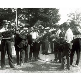 Apiary students examining beehive frames, bees on frames [Hawkesbury Agricultural College (HAC)]
