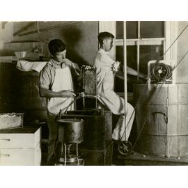 Apiary - Students extracting honey - uncapping the comb with steam heated knife [Hawkesbury Agricultural College (HAC)]