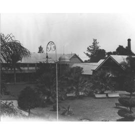 Thompson Block - The dining hall is to the right, garden seats on the lawn, and the Powerhouse chimney in the background [Hawkesbury Agricultural College (HAC)]