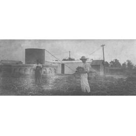 Two students in the vegetable garden with septic system in background [Hawkesbury Agricultural College (HAC)]