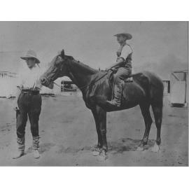 Mounted horseman with another man holding the bridle [Hawkesbury Agricultural College (HAC)]