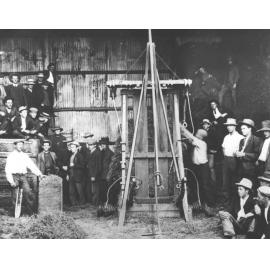 Press for making hay bales - staff & students standing around [Hawkesbury Agricultural College (HAC)]