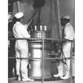 Cannery: Students lowering a retort crate of canned produce into the steam retort [Hawkesbury Agricultural College (HAC)]
