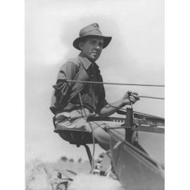 Harvesting hay with three-horse team pulling a reaper and binder - Close-up of one of the men, who has only one arm [Hawkesbury Agricultural College (HAC)]