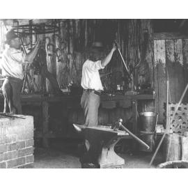 Blacksmith Shop (interior) - Two men working at a bench [Hawkesbury Agricultural College (HAC)]