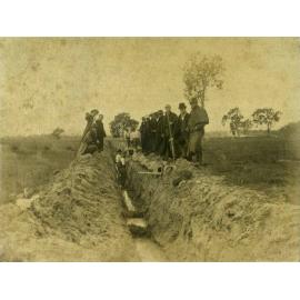 Draining the Orchard, 1892' - two men standing in trough, pipes, others standing on sides of trough, not workers - Uncropped (Print 1 of 2) [Hawkesbury Agricultural College (HAC)]