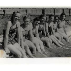 Women's Land Army: Several women sitting on the edge of the swimming pool [Hawkesbury Agricultural College (HAC)]