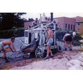 Olympic Swimming Pool - Construction (print 08 of 18) - Working the concreting machine and filling a wheelbarrow with concrete [Hawkesbury Agricultural College (HAC)]
