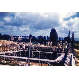 Olympic Swimming Pool - Construction (print 11 of 18) - Students and staff pouring concrete for the top section of wall at deep end of pool [Hawkesbury Agricultural College (HAC)]