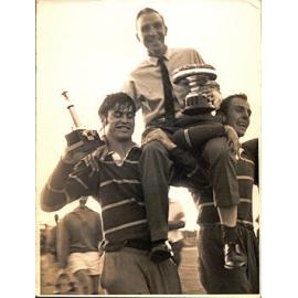 Two rugby players holding Colin Levick (Coach) aloft - 1970's