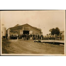 Large group of students outside a shed