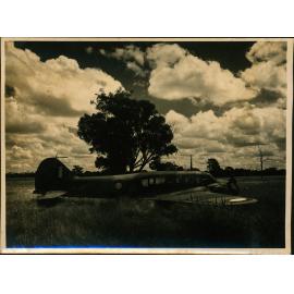 Aeroplane (A4 Avro Anson) in a field (Hoskins Airfield, New Britain Island, Papua New Guinea)