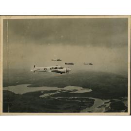 Aerial Photograph - Four A4 Avro Anson planes flying over a river