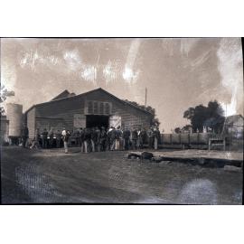 Large group of student outside a shed