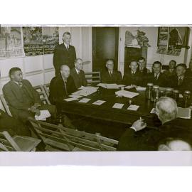 Group of men in suits around a table