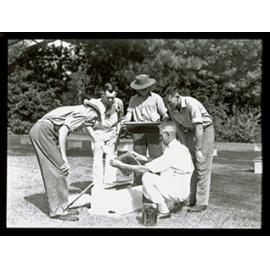 An instructor showing students honeycomb from a hive [Hawkesbury Agricultural College (HAC)]