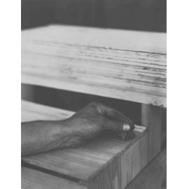 Holding nails in hand ready to make a box/case [Hawkesbury Agricultural College (HAC)]
