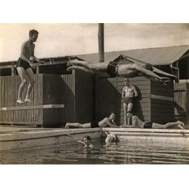 Swimming Pool (first) - Student diving (mid-air) from the board while others watch [Hawkesbury Agricultural College (HAC)]